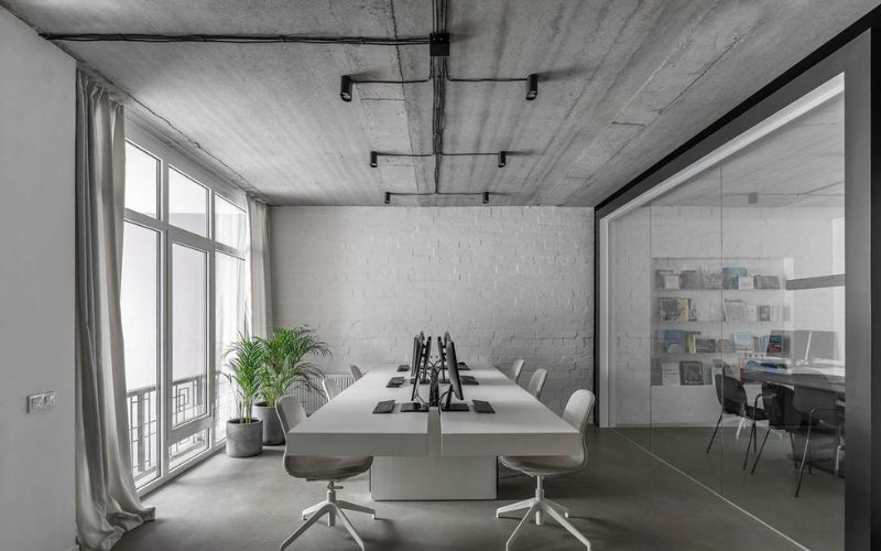 Văn phòng tối giản với tường xi măng, bố trí cây xanh mát mắt