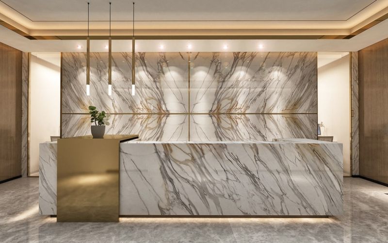 Mẫu quầy lễ tân sang trọng ốp đá marble tự nhiên kết hợp hệ đèn thả trang trí tạo điểm nhấn