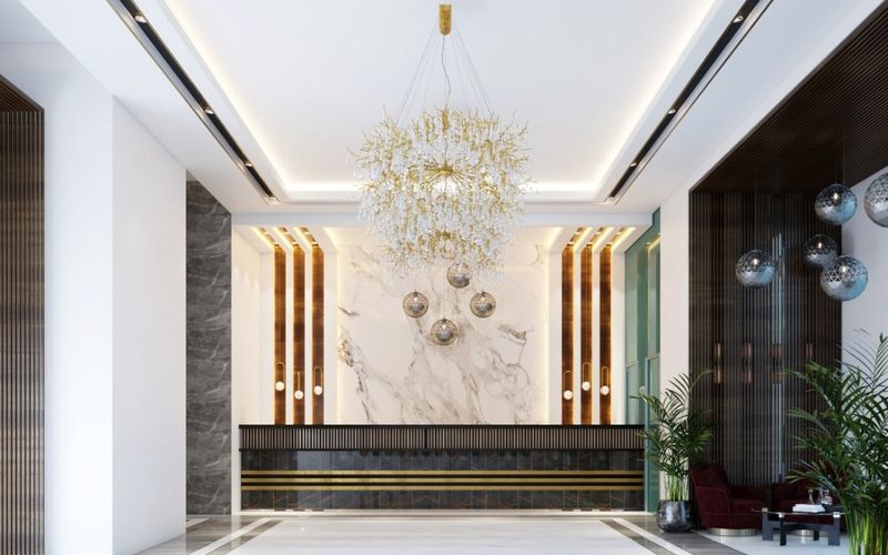 Không gian lễ tân phong cách tân cổ điển kết hợp đèn chùm trang trí và vật liệu gỗ tự nhiên sang trọng